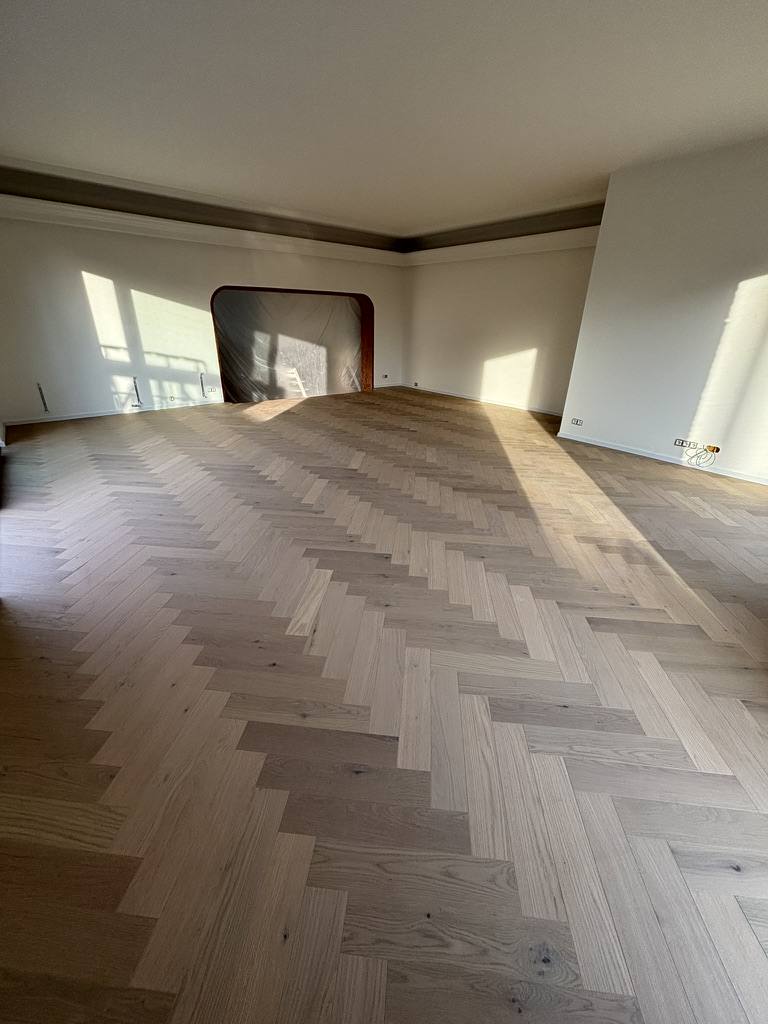 Large room with light oak herringbone parquet