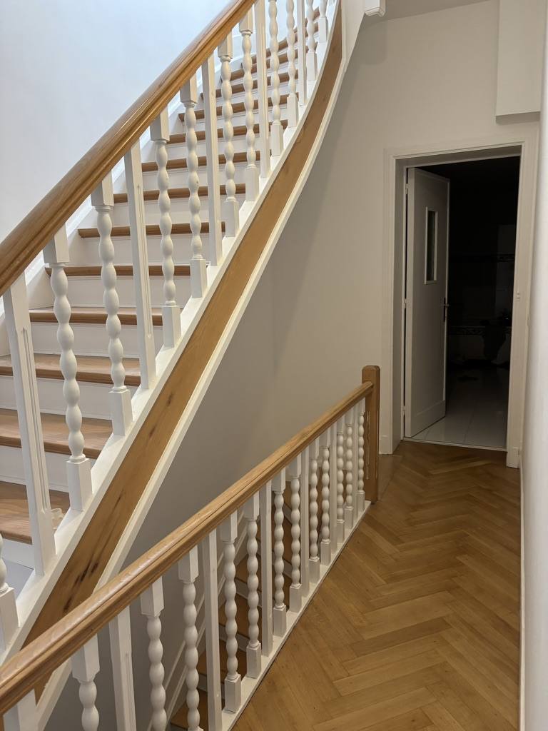 Hallway with herringbone parquet and classic staircase